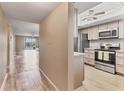 Modern kitchen with stainless steel appliances, ample cabinet space, and adjacent living room at 3204 Lake Bayshore Dr # 407, Bradenton, FL 34205