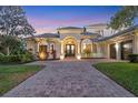 Inviting exterior of a home featuring a circular driveway, tile roof, and well-maintained landscaping at 3432 Founders Club Dr, Sarasota, FL 34240