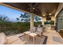 Outdoor kitchen on balcony featuring built-in grill, bar seating, and panoramic views at 3465 Gulfmead Dr, Sarasota, FL 34242