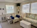 Bright living room with wicker furniture and neutral decor, offering a relaxing space at 3710 Gulf Of Mexico Dr # A20, Longboat Key, FL 34228