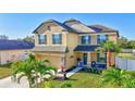 Beautiful two-story home with a well-kept lawn, lovely landscaping, and a welcoming front porch at 4010 Lindever Ln, Palmetto, FL 34221