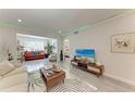 Open concept living room with modern decor and television at 4186 Heron Way # B-219, Bradenton, FL 34205