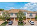 Beautiful townhome exteriors featuring manicured landscaping, multiple garage bays, and ample parking at 4225 Overture Cir, Bradenton, FL 34209
