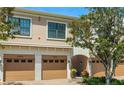 Close-up of well maintained townhome garages with a landscaped walkway at 4225 Overture Cir, Bradenton, FL 34209