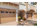 Beautiful townhome garages with paved driveway and manicured landscaping at 4225 Overture Cir, Bradenton, FL 34209