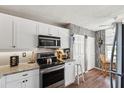 Bright kitchen features white cabinetry, granite countertops, and stainless steel appliances at 4410 Fairways Blvd # 605, Bradenton, FL 34209