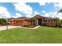 Beautiful single-story home with manicured landscaping and a paver driveway at 5391 90Th Avenue E Cir, Parrish, FL 34219