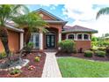 Inviting front entrance with a brick walkway and lush landscaping at 5391 90Th Avenue E Cir, Parrish, FL 34219