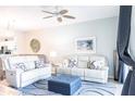 Bright living room with stylish furnishings, including plush sofas with accent pillows and a blue patterned rug at 6334 Grand Oak Cir # 202, Bradenton, FL 34203