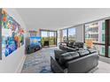 A bright living room with neutral walls, modern furniture, and a large sliding glass door at 707 S Gulfstream Ave # 501, Sarasota, FL 34236