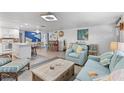 Bright and airy living room with an open floorplan, light hardwood floors, and comfortable modern furniture at 7795 Wright Ave, Sarasota, FL 34231