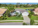 Beautiful one-story home with mature landscaping, golf course view, and two-car garage at 8718 Grey Oaks Ave, Sarasota, FL 34238