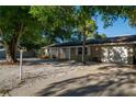 Inviting single-story home features a well-maintained lawn, covered porch, and an attached two-car garage at 95 S Briggs Ave, Sarasota, FL 34237
