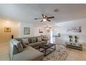 Comfortable living room with a sectional sofa, tiled floors, and an open layout leading to the dining area and kitchen at 95 S Briggs Ave, Sarasota, FL 34237