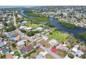 Scenic aerial view of a waterfront neighborhood with lush landscaping and waterfront views at 1156 Lemon Bay Dr, Venice, FL 34293