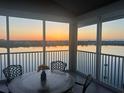 Relaxing lanai with sunset views, table, and chairs at 1280 Dolphin Bay Way # 503, Sarasota, FL 34242
