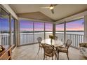 Relaxing patio with views of the water; dining table and chairs; tile floor; ceiling fan at 1280 Dolphin Bay Way # 503, Sarasota, FL 34242