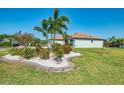 Lush front yard with decorative stone features surrounding trees and shrubbery at 12830 24Th Street E Cir, Parrish, FL 34219