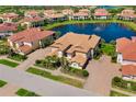Breathtaking aerial view of a luxurious home with a beautiful lake view and well manicured landscaping at 141 Bella Vista Ter # 34D, Nokomis, FL 34275