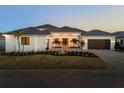 Charming single-story home boasts a brick driveway, three-car garage, and tasteful landscaping at 1613 4Th E St, Palmetto, FL 34221