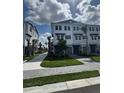 Attractive townhome showcasing well-manicured lawns and charming architectural details under a partly cloudy sky at 1617 Sea Haven Dr # 501, Punta Gorda, FL 33950