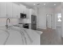 Bright kitchen showcasing white cabinets, stainless steel appliances, and marble countertops at 1617 Sea Haven Dr # 501, Punta Gorda, FL 33950