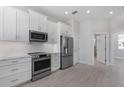 Modern kitchen with white cabinetry, stainless appliances, and sleek countertops at 1617 Sea Haven Dr # 501, Punta Gorda, FL 33950