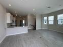 Open-concept living area featuring wood-look floors, natural light, and a seamless transition to the kitchen at 1617 Sea Haven Dr # 501, Punta Gorda, FL 33950