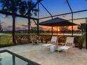 Tranquil screened pool with a sun shelf, relaxing lounge chairs and a picturesque view at 17820 Waterville Pl, Lakewood Ranch, FL 34202