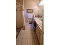 Functional bathroom with a dual-sink vanity, tile flooring, and a shower, providing essential amenities at 1810 Rudder Dr, Valrico, FL 33594
