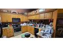 Traditional kitchen equipped with wood cabinetry, appliances, and ample counter space for cooking and storage at 1810 Rudder Dr, Valrico, FL 33594