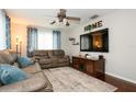 Comfortable living room featuring a leather sofa and entertainment center at 1813 5Th W St, Palmetto, FL 34221
