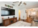 Open-concept living area with hardwood floors and a decorative 'HOME' wall art at 1813 5Th W St, Palmetto, FL 34221