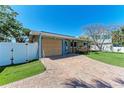 Charming home with a brick driveway, well-maintained lawn, and a freshly painted exterior at 216 Archer Way, Anna Maria, FL 34216