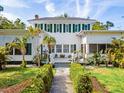 Elegant two-story home with a well-manicured lawn and decorative plants at 2326 2Nd E Ave, Bradenton, FL 34208
