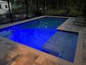 Relaxing screened-in pool with spa at night at 2326 2Nd E Ave, Bradenton, FL 34208