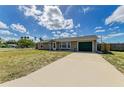 Inviting single-Gathering home with a spacious driveway and tidy front lawn under a partly cloudy sky at 3119 40Th W Ave, Bradenton, FL 34205