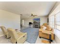 Comfortable living room featuring a fireplace, ceiling fan and a large bay window with plenty of natural light at 3119 40Th W Ave, Bradenton, FL 34205
