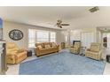 Bright living room boasts a big bay window, ceiling fan, and ample seating creating a cozy atmosphere at 3119 40Th W Ave, Bradenton, FL 34205