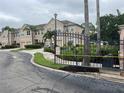Gated entry showing landscaping and townhomes within the community at 3938 Yellowstone Cir, Sarasota, FL 34233