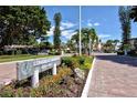 Longboat Harbour community sign surrounded by lush landscaping and colorful flowers at 4350 Chatham Dr # E-105, Longboat Key, FL 34228