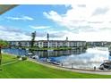 Beautiful water view from condo with boats docked along the canal and green grassy areas at 4350 Chatham Dr # E-105, Longboat Key, FL 34228