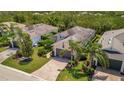 A beautifully landscaped single-Gathering home features palm trees and a brick-paved driveway at 5009 Lake Overlook Ave, Bradenton, FL 34208