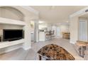 Open-concept living room, showing the adjacent kitchen with bar seating and dining area at 5134 Northridge Rd # 106, Sarasota, FL 34238