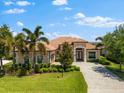 Beautiful single-story home with tile roof, well-manicured lawn, and lush landscaping at 5637 Arnie Loop, Bradenton, FL 34211