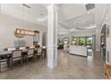 Spacious living room and dining room featuring tile floors, high ceilings, and lots of natural light at 5637 Arnie Loop, Bradenton, FL 34211