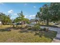 Charming home with a large tree and landscaped front yard at 5728 Whistlewood Cir, Sarasota, FL 34232