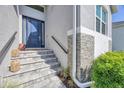 Home's stone-accented front exterior showcases a modern blue door and tiled steps at 6228 Champions Row St, Bradenton, FL 34210