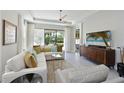 Relaxing living room featuring comfortable seating, tile floors, and sliding glass doors that lead to the outdoors at 6308 Plateau Ct, Bradenton, FL 34203