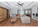 Spacious open-concept living room boasts wood floors and abundant natural light, perfect for entertaining at 6407 213Th E St, Bradenton, FL 34211